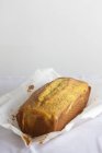 Крупный план апельсинового и макового хлеба на бумаге для выпечки — стоковое фото