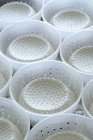 Fresh ricotta in plastic bowls — Stock Photo