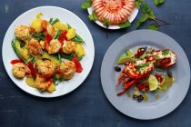 Three crustacean dishes: prawns with fruit, a ring of prawns amd lobster — Stock Photo