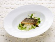 Asparagus risotto with pan-fried sea bass — Stock Photo