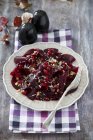 Beetroot carpaccio with redcurrants and horseradish on white plate over towel — Stock Photo