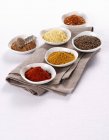 Elevated view of assorted spices in white bowls — Stock Photo