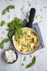 Top view of a Frittata with basil in a frying pan — Stock Photo