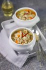 Closeup view of Trentino Orzotto with speck in white bowls — Stock Photo