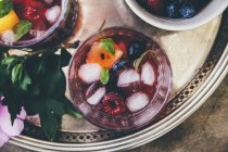 Closeup top view of berry drinks with ice cubes — Stock Photo