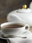 Cup of tea and teapot — Stock Photo