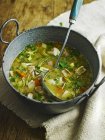 Closeup view of chicken soup in a stock pot — Stock Photo