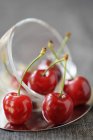 Cherries in glass cup — Stock Photo