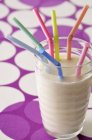 Glass of milk with straws — Stock Photo
