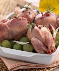 Raw quail with grapes — Stock Photo