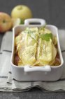 Artiflette with apples in tray — Stock Photo