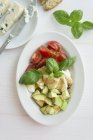 Tomatoes, mozzarella and avocado — Stock Photo