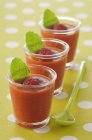 Raspberry soup with peppermint in glasses over green cloth — Stock Photo