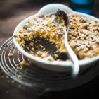 Closeup view of chocolate Crumble with spoon in bowl — Stock Photo