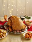 Whole Turkey  with vegetables and Thanksgiving decorations — Stock Photo