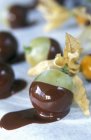 Closeup view of chocolate dipped fruits — Stock Photo