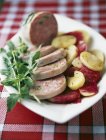 Pistachio saucisson with potatoes — Stock Photo