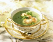 Closeup view of creamed pea soup with herbs and prawns — Stock Photo