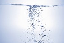 Closeup view of air bubbles ascending in water — Stock Photo