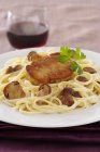 Linguine pasta with ceps and duck — Stock Photo