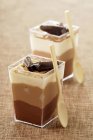 Closeup view of two chocolate Verrines in square glasses with spoons — Stock Photo