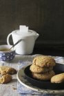 Tea and biscuits on plates — Stock Photo