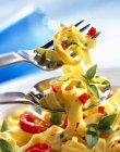 Tagliatelle pasta with basil and tomatoes — Stock Photo