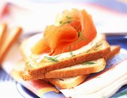 Smoked salmon and cream on toast — Stock Photo