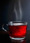Hot red berry fruit tea in glass mug — Stock Photo