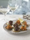 Smoked salmon and beef belini canapes — Stock Photo