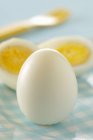 Whole and halved Hard-boiled eggs — Stock Photo