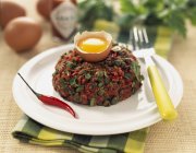 Steak tartare with peppers — Stock Photo