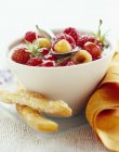 Closeup view of salad with berries in jasmine sauce and crunchy sticks — Stock Photo