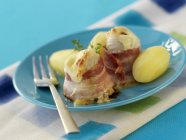 Fish fillets wrapped in bacon — Stock Photo