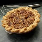 Closeup view of pecan pie with whisk — Stock Photo