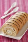 Closeup view of rolled biscuit filled with cream — Stock Photo
