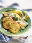 Closeup view of herb omelette fritters on green plate — Stock Photo