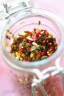 Closeup view of mixed spices and nuts in glass jar — Stock Photo