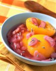 Closeup view of rhubarb and peaches with lavender in bowl — Stock Photo