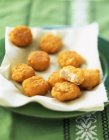 Chicken nuggets on paper — Stock Photo