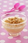 Pear soup with cashews in glass bowl over pink surface — Stock Photo