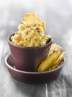 Artichoke spread in small pot over plate  over wooden surface — Stock Photo
