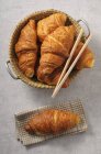 Fresh croissants in a basket — Stock Photo