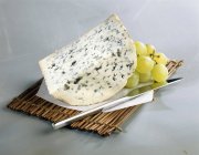 Roquefort on paper over straw — Stock Photo