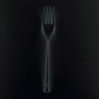 Closeup view of one fork on black background — Stock Photo