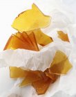 Caramel pieces in paper — Stock Photo