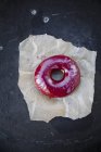 Closeup top view of blueberry donut on paper — Stock Photo