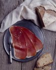 Sliced Bayonne ham on platter — Stock Photo