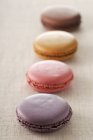 Macaroons on textile surface — Stock Photo