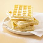 Waffles with icing sugar on plate — Stock Photo